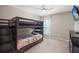 Bunk room with dark wood frame and dresser, ceiling fan, and window at 3818 Tupelo Church Ln, Mount Pleasant, SC 29429