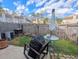 Fenced backyard with a small patio area, grass and a metal table with umbrella at 409 Reserve Way, Summerville, SC 29485