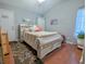 Bright bedroom with hardwood floors, decorated with a comfortable bed, and floral rug at 409 Reserve Way, Summerville, SC 29485
