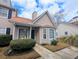 Tan townhouse featuring well-maintained bushes, siding and brown shingles at 409 Reserve Way, Summerville, SC 29485