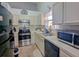 Well-equipped kitchen with white cabinets, stainless steel appliances, and ample countertop space for meal preparation at 409 Reserve Way, Summerville, SC 29485