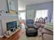 Inviting living room with a charming fireplace, comfortable seating, and stylish decor, creating a cozy atmosphere at 409 Reserve Way, Summerville, SC 29485