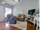 Comfortable living room featuring a plush recliner, cozy sofa, and modern entertainment center, ideal for relaxing at 409 Reserve Way, Summerville, SC 29485