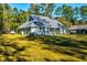 Well-maintained home with a screened porch, overlooking a spacious and verdant backyard at 418 Myers Mayo Rd, Ridgeville, SC 29472