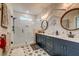 A stunning bathroom features glass enclosed shower, patterned floor tiles and dual sink vanity at 418 Myers Mayo Rd, Ridgeville, SC 29472