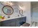 Bright bathroom features a double vanity with round mirrors and stylish patterned tile floor at 418 Myers Mayo Rd, Ridgeville, SC 29472
