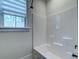 Bathroom features a shower, bathtub, and window for natural light at 418 Myers Mayo Rd, Ridgeville, SC 29472