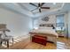 Bedroom with hardwood floors, tray ceiling, accent wall art, and window with shade at 418 Myers Mayo Rd, Ridgeville, SC 29472