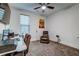 Comfortable bedroom with a plush recliner, ceiling fan, and natural light from the window at 418 Myers Mayo Rd, Ridgeville, SC 29472