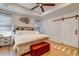 Spacious bedroom featuring a tray ceiling, wooden floors, and a barn door at 418 Myers Mayo Rd, Ridgeville, SC 29472