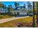 Lovely house with a long driveway and garage, surrounded by lush green lawns at 418 Myers Mayo Rd, Ridgeville, SC 29472