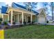 Charming home featuring a welcoming front porch and attached two-car garage at 418 Myers Mayo Rd, Ridgeville, SC 29472