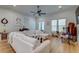 Bright living room with white sofas, hardwood floors, and large windows at 418 Myers Mayo Rd, Ridgeville, SC 29472