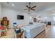 Spacious living room featuring white sectional sofa and modern furnishings with views to kitchen at 418 Myers Mayo Rd, Ridgeville, SC 29472