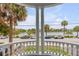 Picturesque view from a balcony with white railings and columns, overlooking a street with waterfront views at 47 Ashley Ave, Charleston, SC 29401