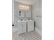 Bathroom featuring dual sinks, mosaic tile floors, modern lighting and a window at 47 Ashley Ave, Charleston, SC 29401