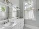 Bright bathroom with double sinks, marble countertop, and modern fixtures at 47 Ashley Ave, Charleston, SC 29401
