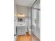 Bathroom featuring a shower with glass doors, a mirror, and a vanity with drawers at 47 Ashley Ave, Charleston, SC 29401