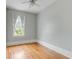 Spacious bedroom with hardwood floors, light gray walls, and a large window at 47 Ashley Ave, Charleston, SC 29401