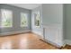 Large bedroom with three windows, hardwood floors, and a decorative fireplace at 47 Ashley Ave, Charleston, SC 29401