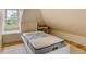 Bedroom under an eave with a full size bed and a window with a view at 47 Ashley Ave, Charleston, SC 29401