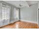 Large bedroom features hardwood floors, soft gray walls, a ceiling fan, and large windows at 47 Ashley Ave, Charleston, SC 29401