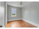 Bright bedroom with light gray walls, hardwood floors and a large window with treetop views at 47 Ashley Ave, Charleston, SC 29401