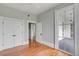 Bright bedroom featuring hardwood floors, a ceiling fan, a large window, and a double-door closet at 47 Ashley Ave, Charleston, SC 29401