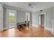 Spacious dining room with hardwood floors, a ceiling fan, and a large door to the home's outdoor balcony at 47 Ashley Ave, Charleston, SC 29401