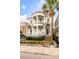 Charming two-story home featuring double balconies with columns, a brick staircase and a manicured front yard at 47 Ashley Ave, Charleston, SC 29401