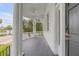 Inviting front porch with white columns, a ceiling fan, and a dark wood floor with views of the nearby trees at 47 Ashley Ave, Charleston, SC 29401