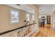 Hallway with wooden floors and a staircase view of kitchen and outdoor scenery through the window at 47 Ashley Ave, Charleston, SC 29401
