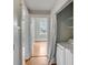 Hallway with a washer and dryer hook-up featuring hardwood floors and white trim at 47 Ashley Ave, Charleston, SC 29401