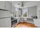 Charming kitchen featuring stainless appliances, hardwood floors, and ample natural light at 47 Ashley Ave, Charleston, SC 29401