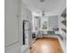 View of kitchen including stainless steel appliances, hardwood floors, window, and storage space at 47 Ashley Ave, Charleston, SC 29401
