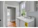 Bright laundry room with white cabinets, a window, and a washer and dryer at 47 Ashley Ave, Charleston, SC 29401