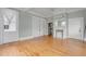 An open living area has gorgeous hardwood flooring, light gray walls, and a stunning fireplace at 47 Ashley Ave, Charleston, SC 29401
