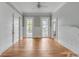 An open living area features gorgeous flooring, detailed trim, and large windows at 47 Ashley Ave, Charleston, SC 29401