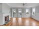 Bright living room featuring hardwood floors, a decorative fireplace, and large windows with a balcony view at 47 Ashley Ave, Charleston, SC 29401