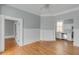 A large open living area features hardwood floors, light gray walls, and access to the kitchen at 47 Ashley Ave, Charleston, SC 29401