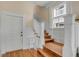 Staircase with wood floors, white trim, and a small table underneath window at 47 Ashley Ave, Charleston, SC 29401