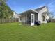 Spacious backyard featuring a screened porch and well-kept lawn at 4875 Carnoustie Ct, Summerville, SC 29485