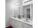Bathroom featuring a double sink vanity, mirrors, and modern lighting at 4875 Carnoustie Ct, Summerville, SC 29485