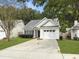 Charming one-story home with a well-manicured lawn and driveway at 4875 Carnoustie Ct, Summerville, SC 29485