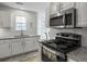 Modern kitchen featuring white cabinetry, stainless steel appliances, and granite countertops at 4875 Carnoustie Ct, Summerville, SC 29485