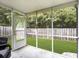 View of the screened porch, the yard, and the privacy fence at 4875 Carnoustie Ct, Summerville, SC 29485