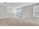 This carpeted bedroom is a bright, neutral space with three windows at 4996 Song Sparrow Way, Summerville, SC 29483