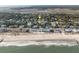 Expansive aerial shot of a beach home neighborhood nestled between the ocean and a winding river, offering stunning water views at 507 Pompano St # 1/3 Share, Edisto Island, SC 29438