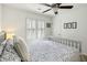 Bright bedroom featuring a queen-size bed, white walls, a ceiling fan, and ample natural light at 524 Cobby Creek Ln, Seabrook Island, SC 29455