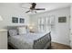 Bright bedroom with nautical decor, queen bed, shuttered window and a ceiling fan at 524 Cobby Creek Ln, Seabrook Island, SC 29455